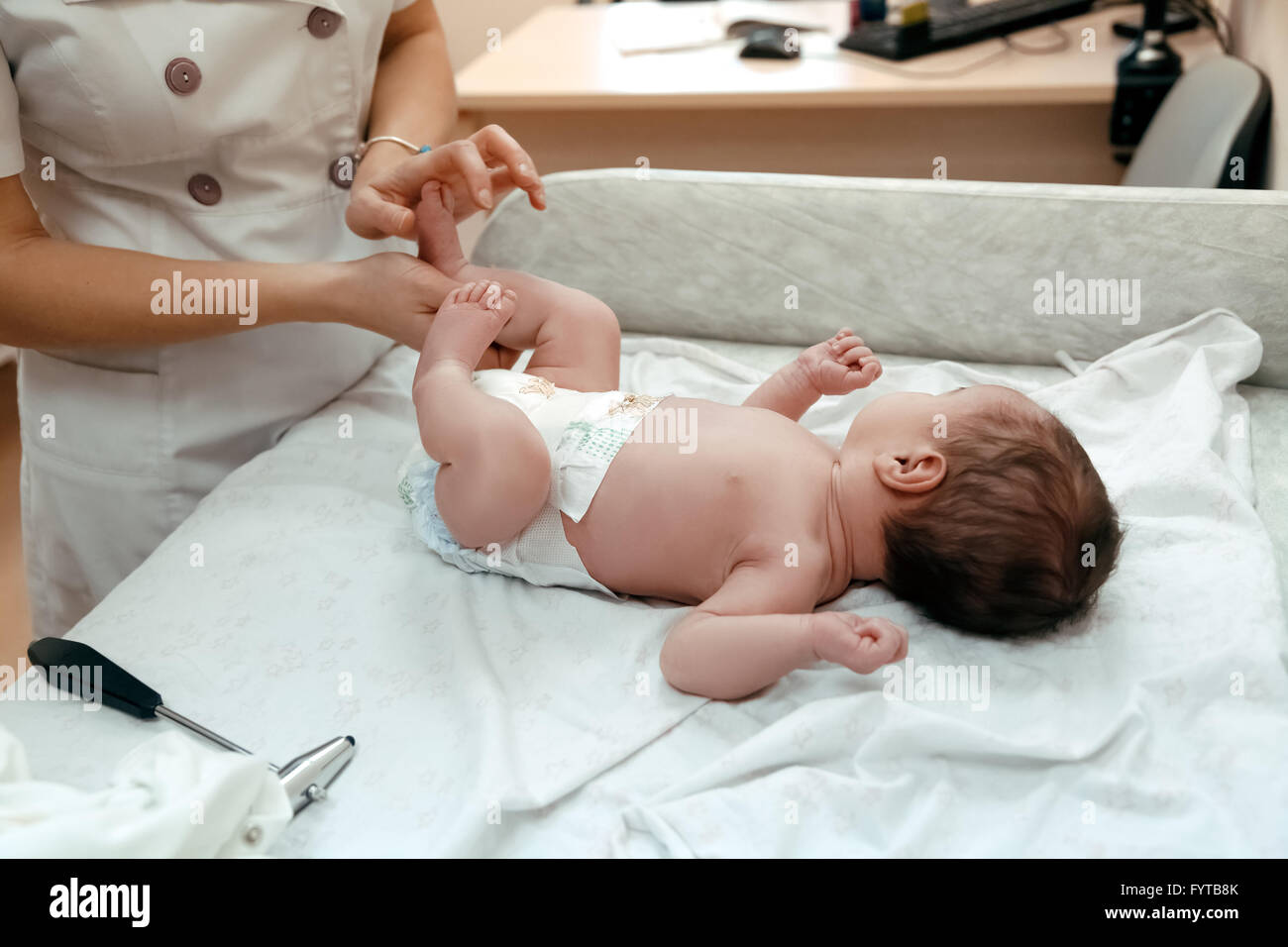 Pediatrician examining littlle newborn baby Stock Photo