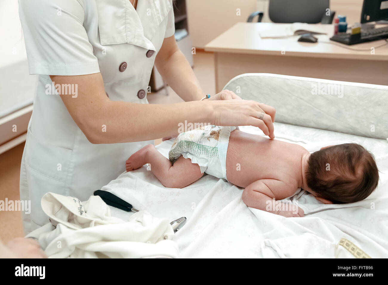 Pediatrician examining littlle newborn baby Stock Photo
