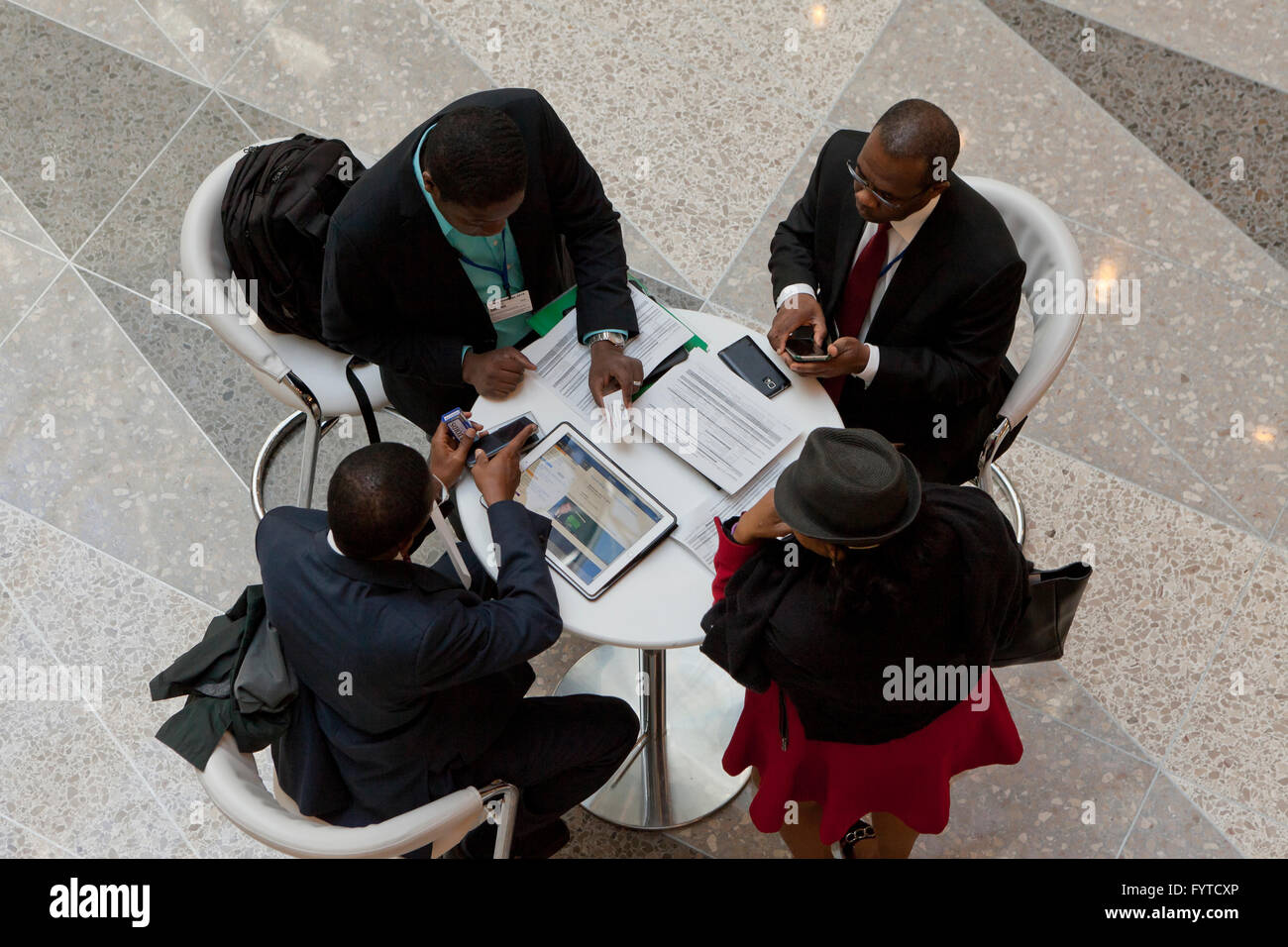 African businessmen in a business meeting working at a small table - USA Stock Photo