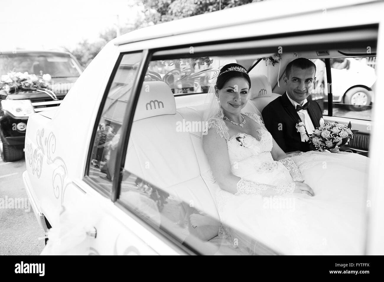 Wedding love couple together at limousine Stock Photo