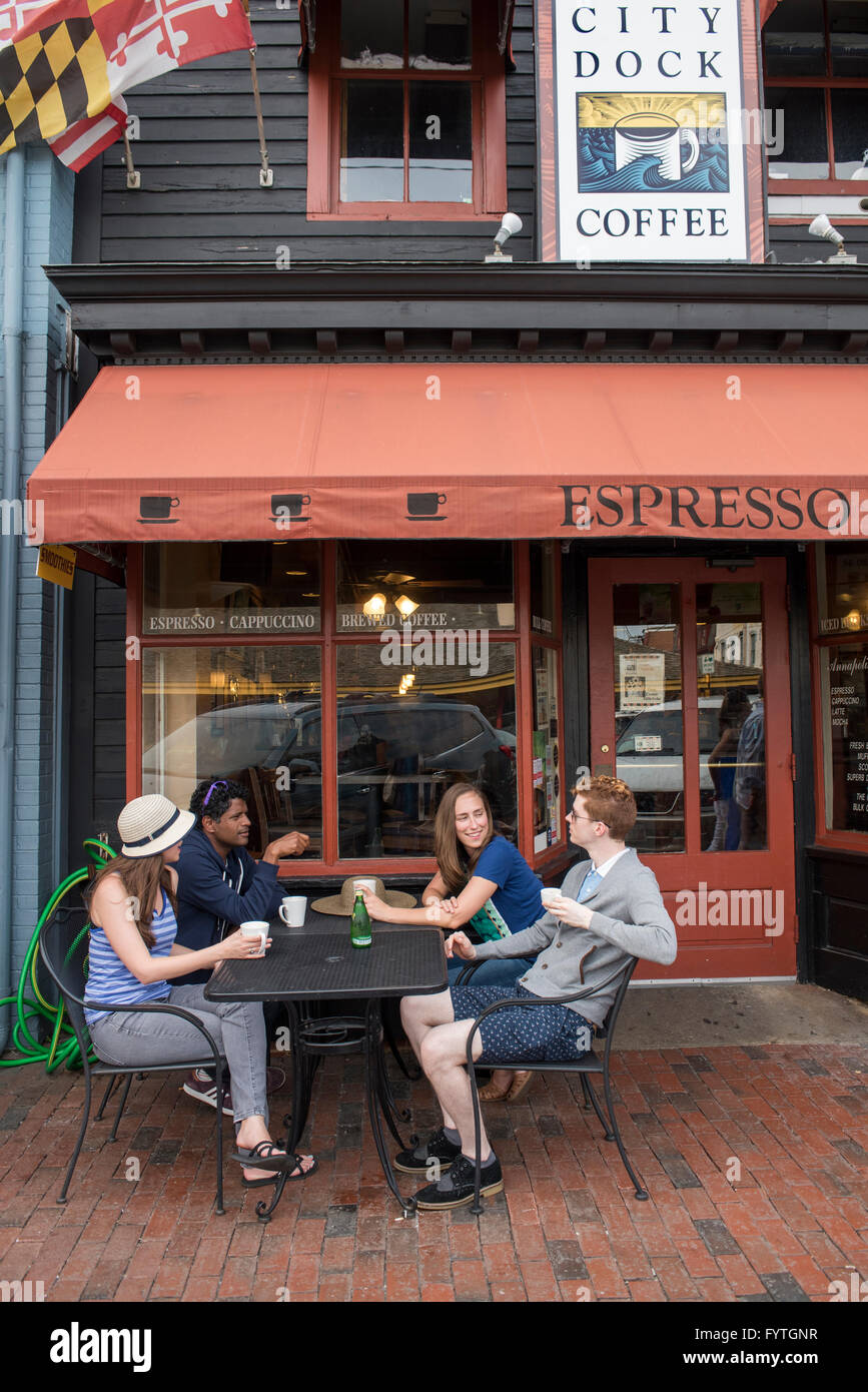 Friends sit in front of a coffee shop in Annapolis, Maryland Stock