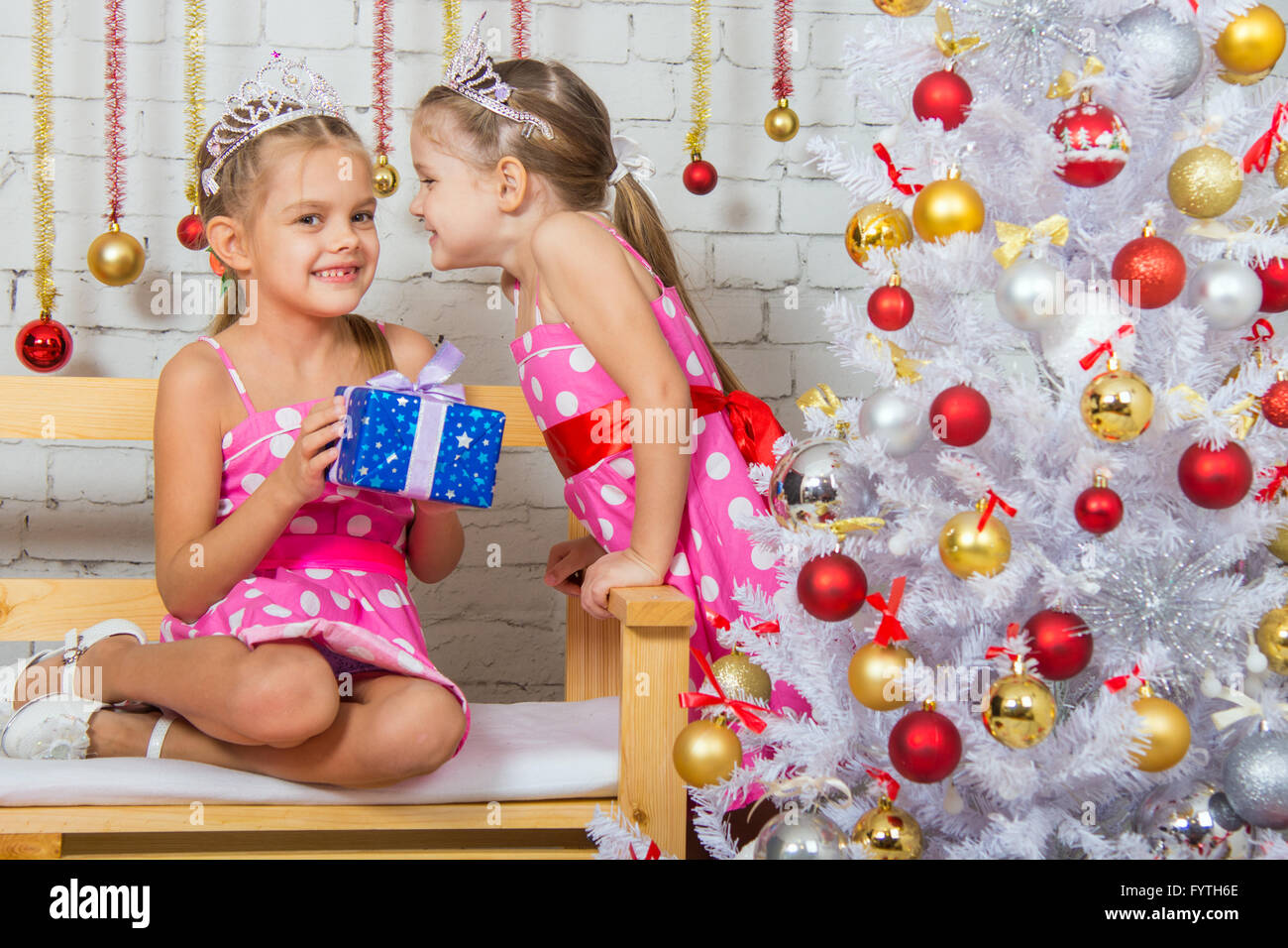 Two girls were talking about the Christmas tree Stock Photo