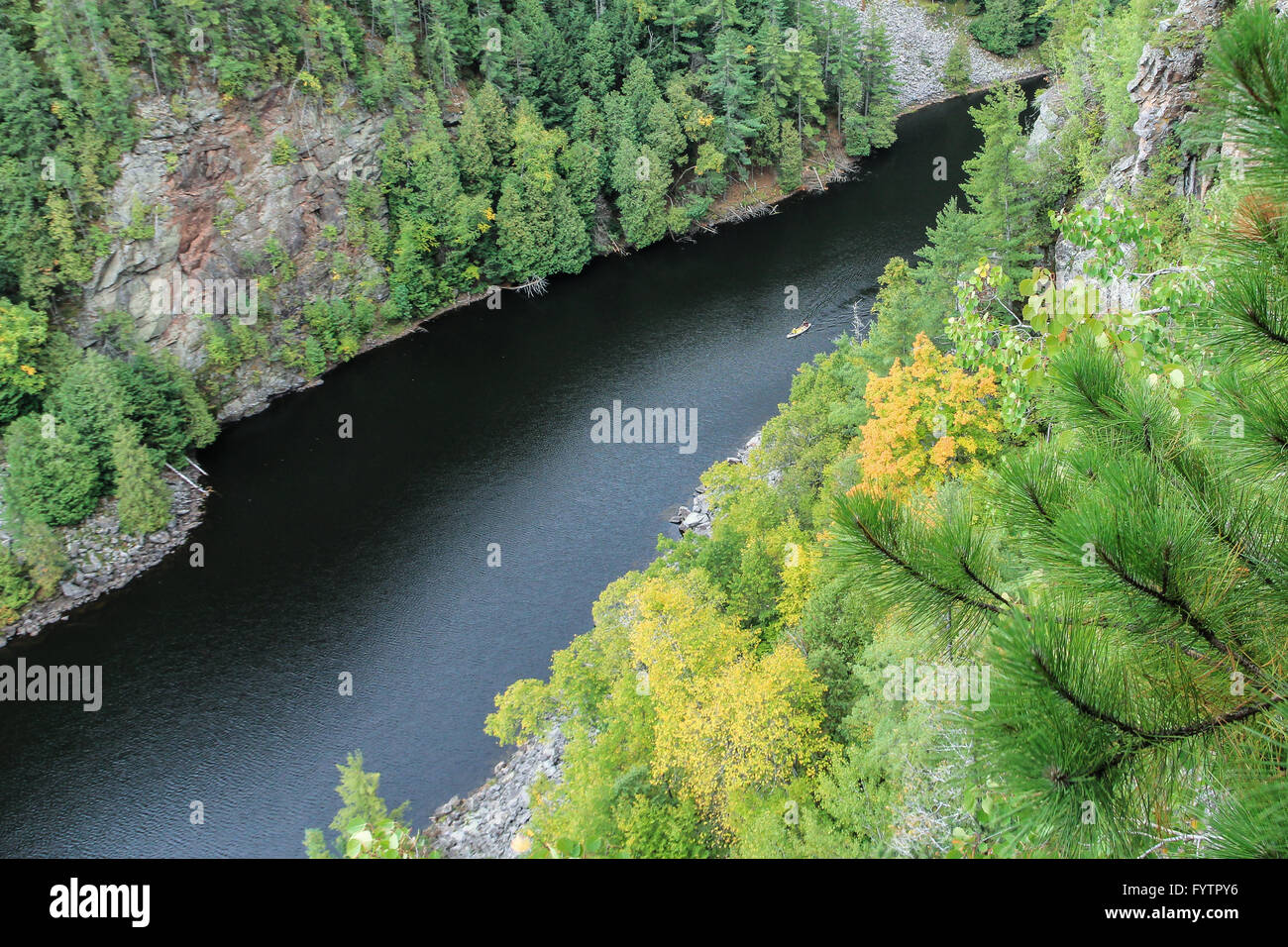 A canoe down below on the Barron River as seen from the cliffs of the Barron Canyon in Algonquin Park, Ontario, Canada Stock Photo