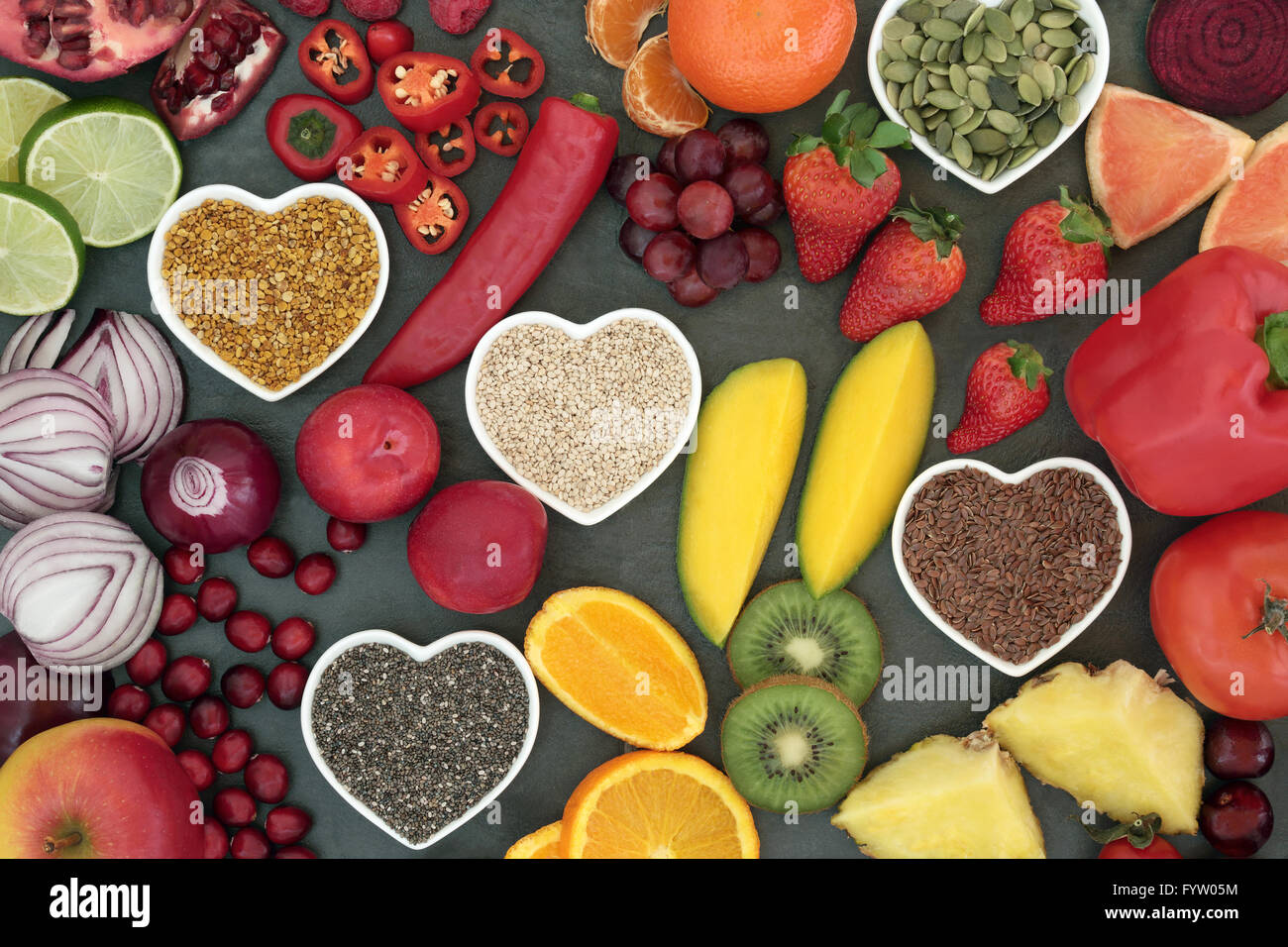Paleo diet health and super food of fruit, vegetables, nuts and seeds in heart shaped bowls on