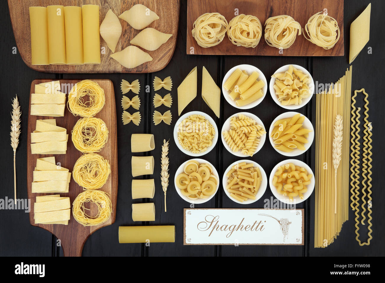 Dried italian pasta food selection on maple boards and in porcelain