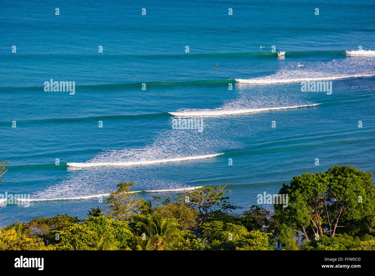 OSA PENINSULA, COSTA RICA - Pacific Ocean waves breaking at Pan Dulce beach, and rain forest. Stock Photo