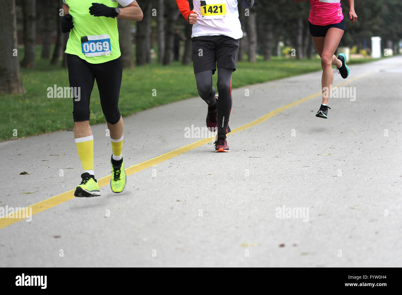 Three people running Cross country Marathon, Blured Motion Stock Photo