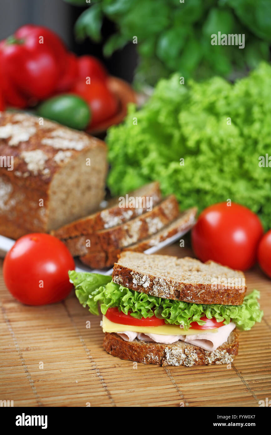 Double sandwich with brown bread, ham, lettuce, tomato, cheese Stock Photo Alamy