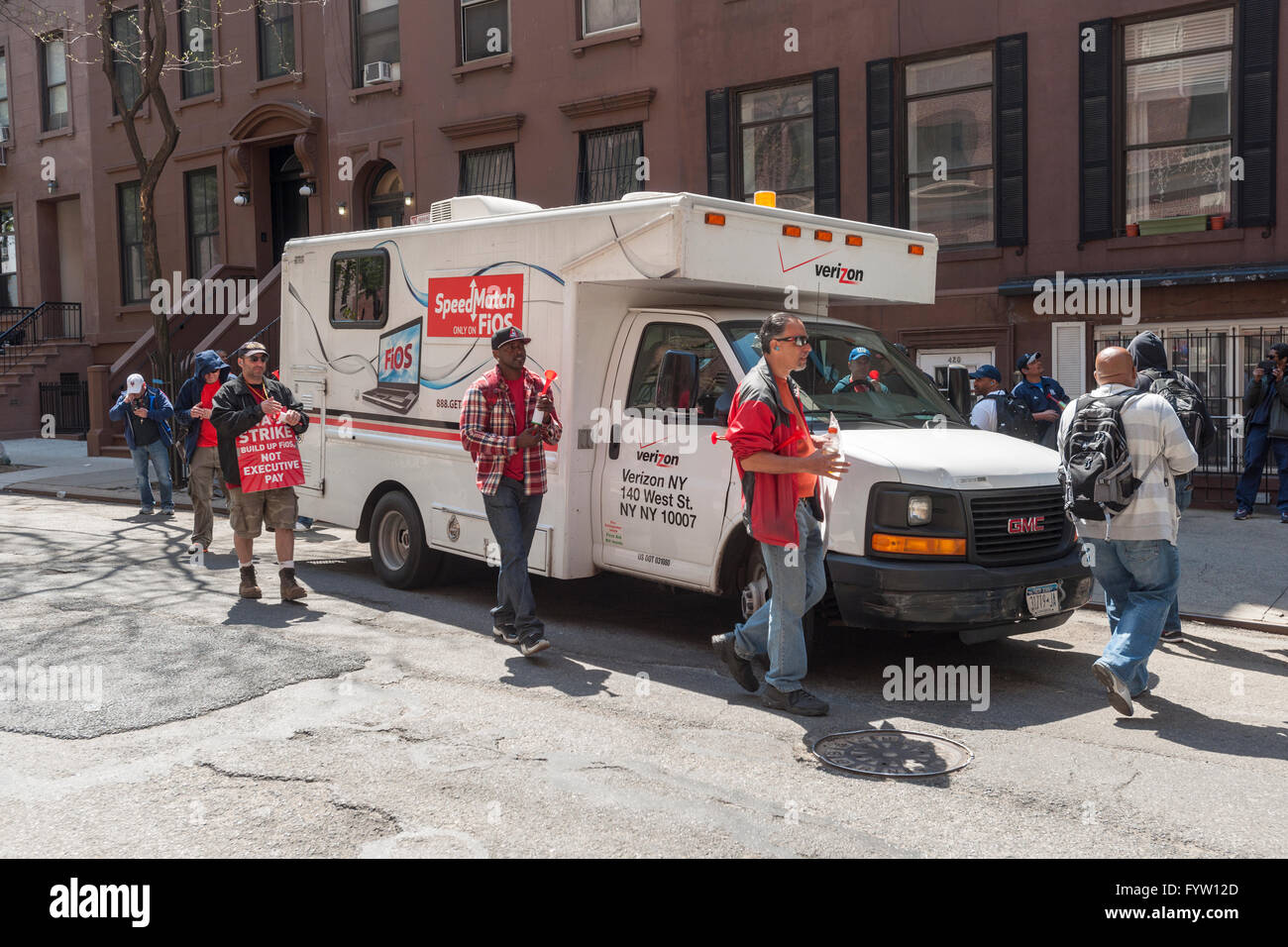 Armed with horns and their loud voices striking Verizon workers surround a Verizon service vehicle in the Hell's Kitchen neighborhood of New York on Thursday, April 21, 2016. Almost 40,000 members of the Communications Workers of America and the International Brotherhood of Electrical Workers walked out in nine eastern states and Washington DC over various contract disputes including healthcare and scheduling flexibility. (© Richard B. Levine) Stock Photo