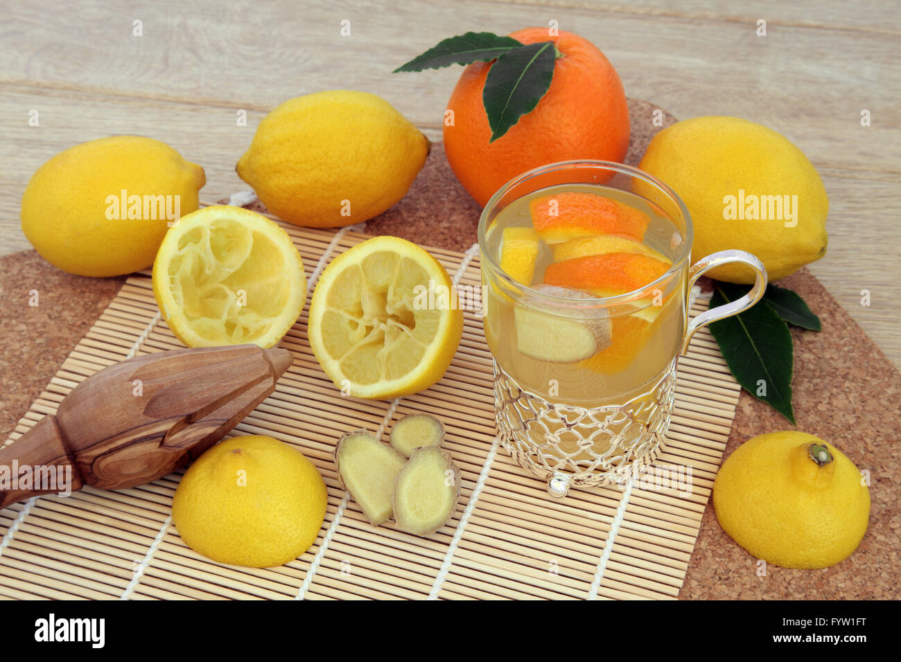 Alternative cold remedy with orange, lemon, ginger spice and honey drink with freshly squeezed