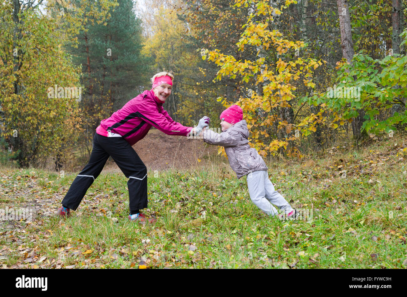 Woman with girl doing aerobics in the park Stock Photo