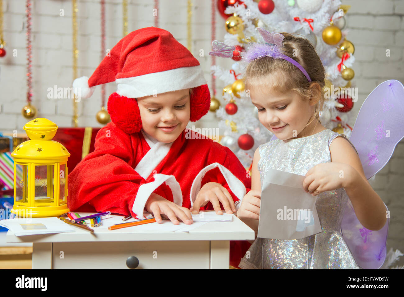 Santa Claus and fairy helper packaged in envelopes greeting letter Stock Photo