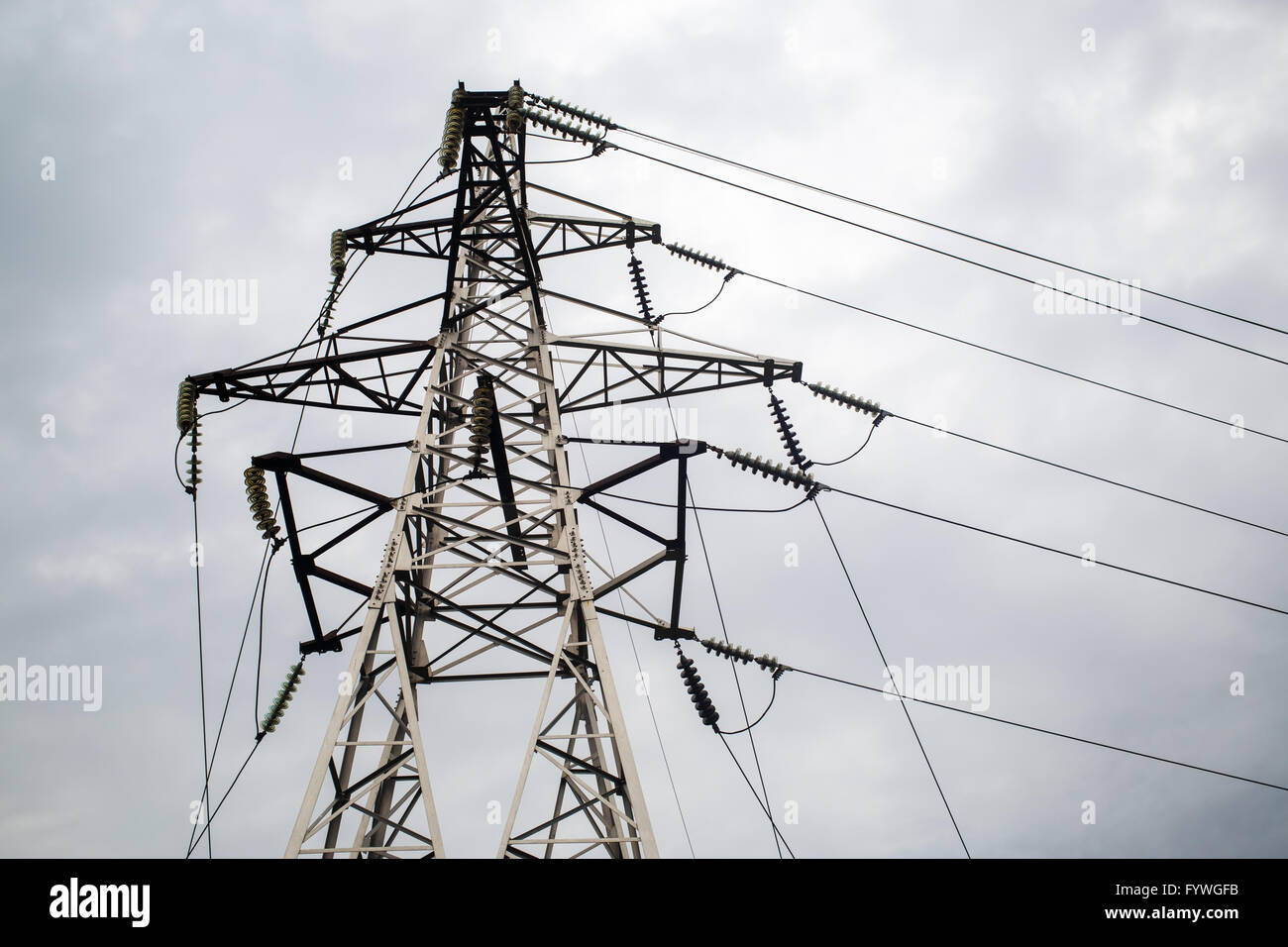 Electricity pylon against cloudy sky Stock Photo