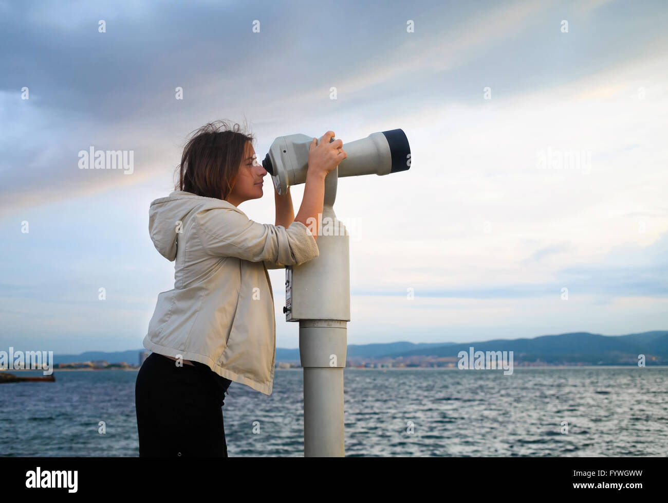 Woman look in pay binocular Stock Photo