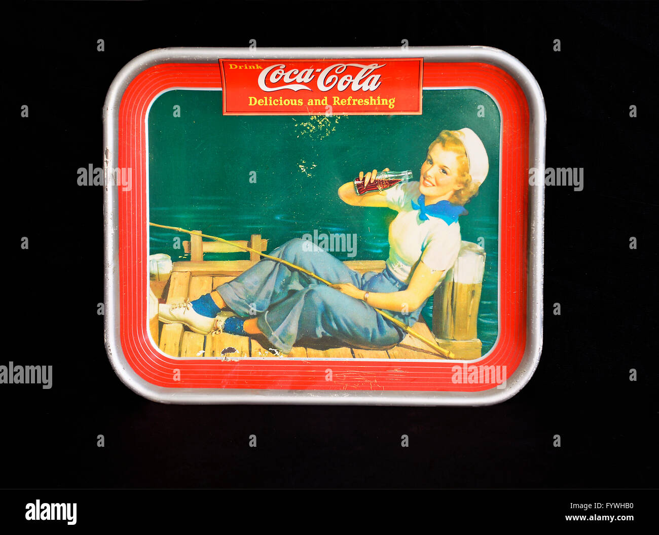 Vintage 1940's tin Coca-Cola advertising serving tray, Girl sitting on a pier with fishing rod. Stock Photo