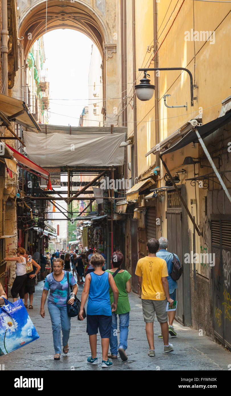 Naples, Italy - August 9, 2015: Narrow street of Naples, ordinary people and tourists walk on old part of city Stock Photo