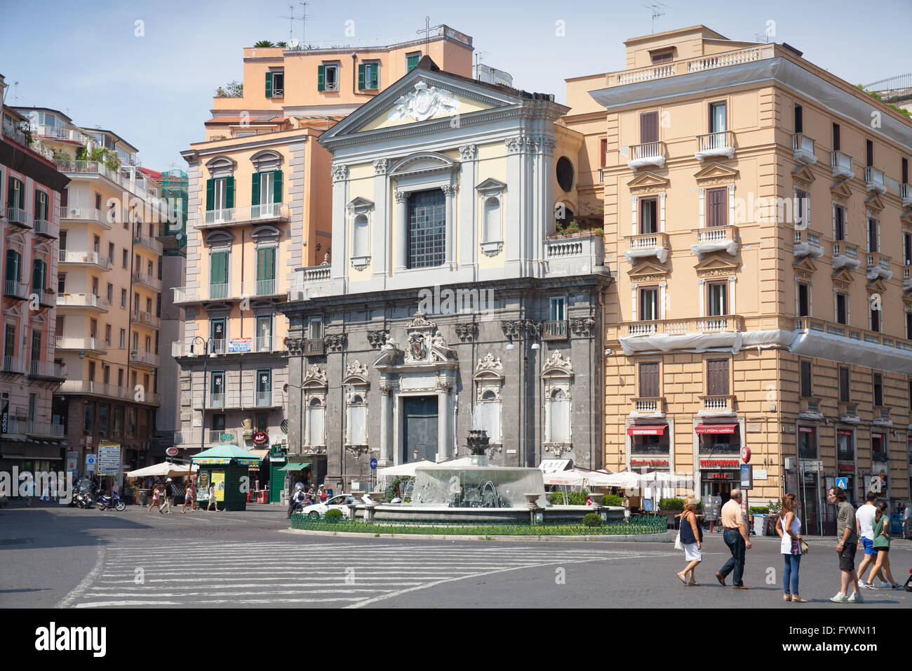 Naples, Italy - August 9, 2015: Ordinary people walking on Piazza Trieste E Trento, street view with facade of Galleria Umberto Stock Photo