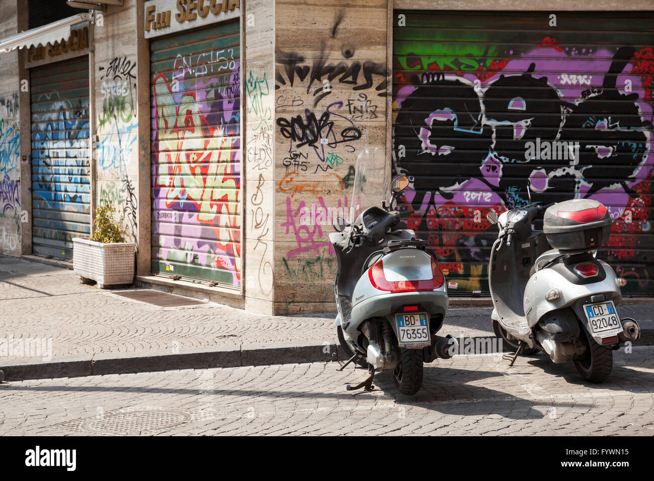 Naples, Italy - August 9, 2015: Two scooters parked on a roadside in Naples Stock Photo