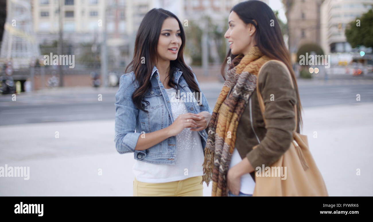 Woman meets girl. Woman meets girl. Woman meets girl. Two friends talking. Women meeting.