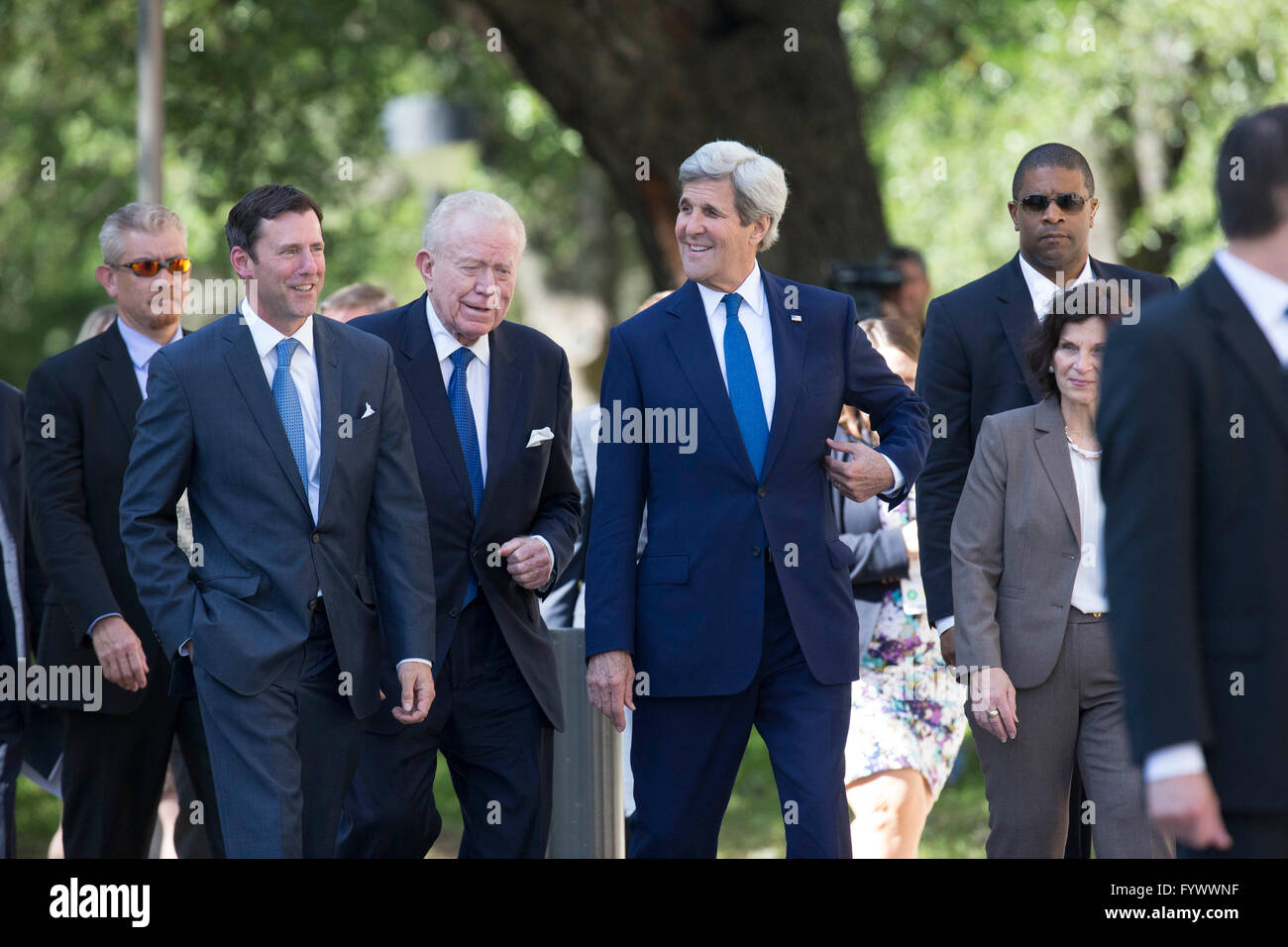 U.S. Secretary of State John Kerry, center, arrives at the LBJ Library for a keynote speech during the Vietnam War Summit. Stock Photo