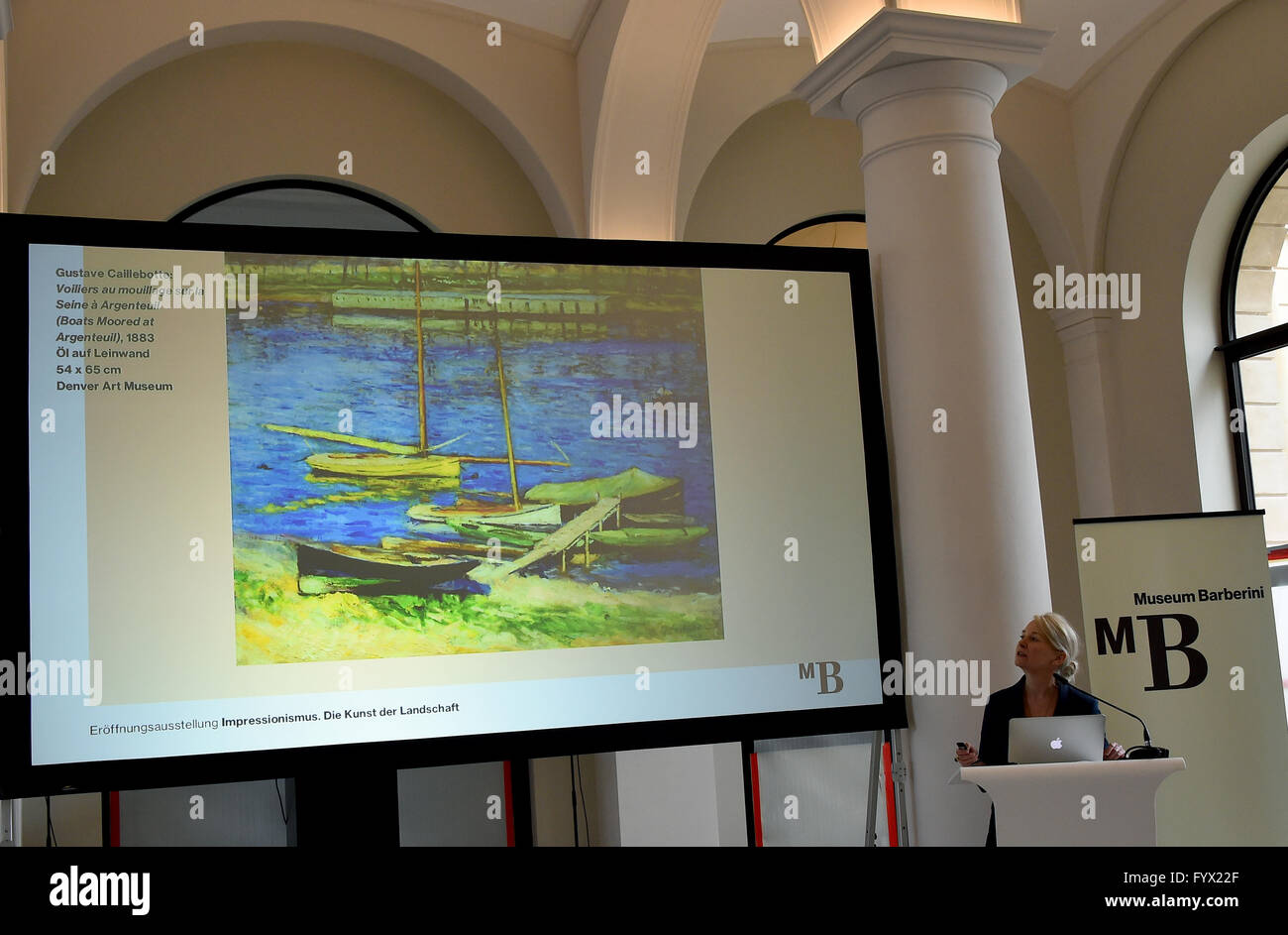 Museum director Ortrud Westheider presents the concept of the first exhibitions to be held in the Barberini Museum scheduled to open in January 2017, with a projection of a painting by Gustave Caillebotte pictured next to her, in the lobby of the future museum in Potsdam, Germany, 28 April 2016. Photo: BERND SETTNIK/dpa Stock Photo