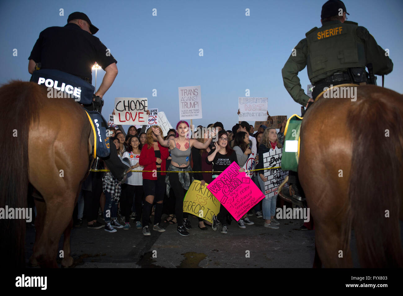 Orange County, California, USA. 28th Apr, 2016. Protesters react outside a Donald Trump campaign rally in Orange County, southern California, April 28, 2016. Supporters and opponents of the Republican presidential front-runner Donald J. Trump confronted for a few hours on Thursday to express their different opinions. Credit:  Yang Lei/Xinhua/Alamy Live News Stock Photo