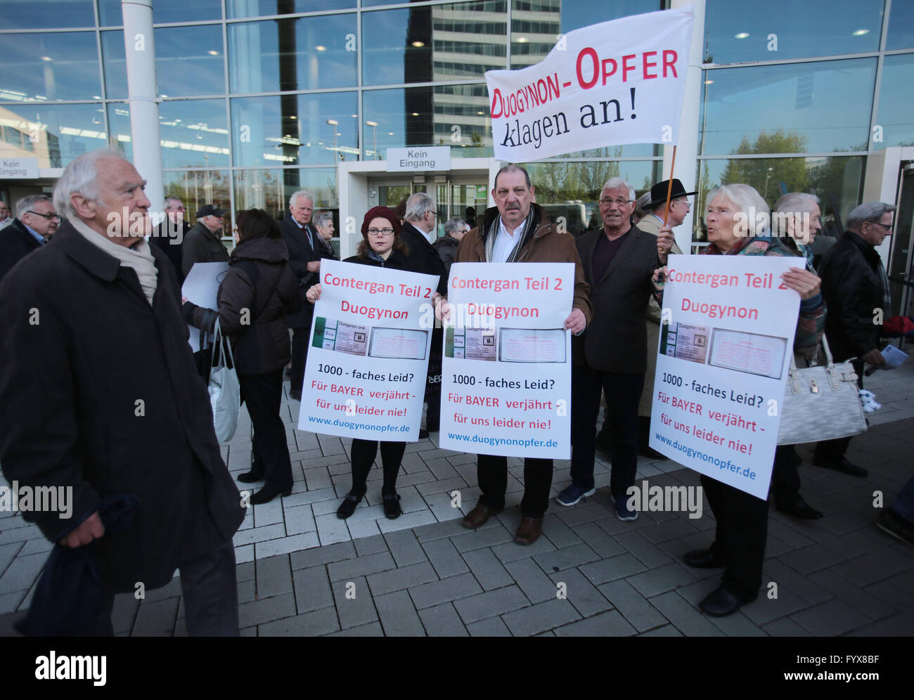 Cologne, Germany. 29th Apr, 2016. Participants holding posters reading 'Contergan Teil 2 - Duogynon 1000-faches Leid - Für Bayer verjährt, für uns leider nie' during a demonstration during the general assembly of Bayer in Cologne, Germany, 29 April 2016. PHOTO: OLIVER BERG/dpa/Alamy Live News Stock Photo