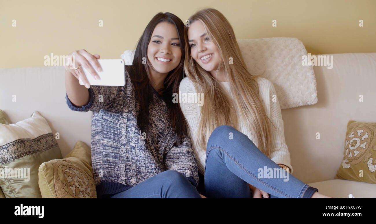 Two pretty girls posing for a selfie Stock Photo - Alamy