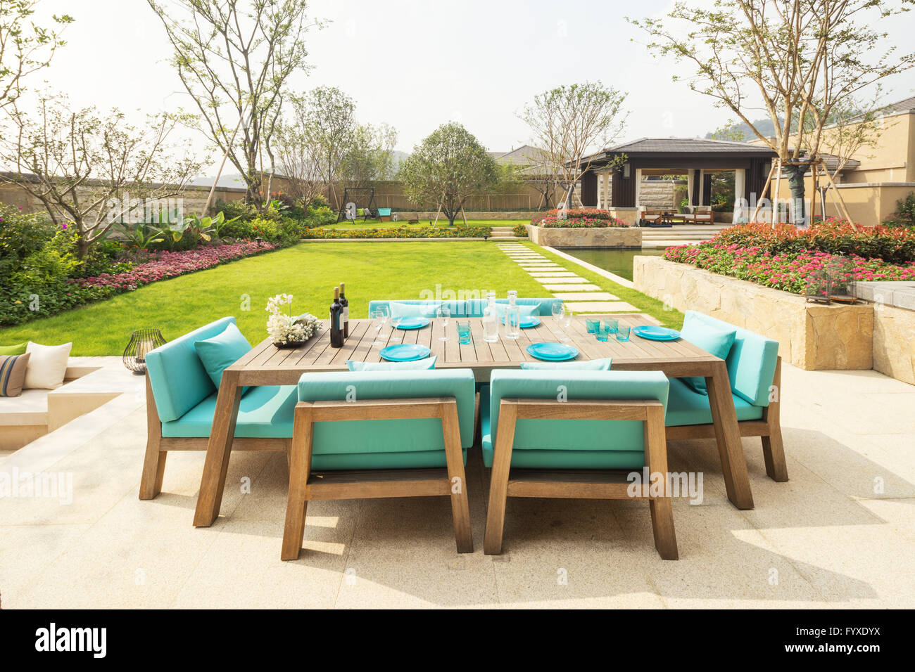 elegant chairs and table in backyard Stock Photo Alamy