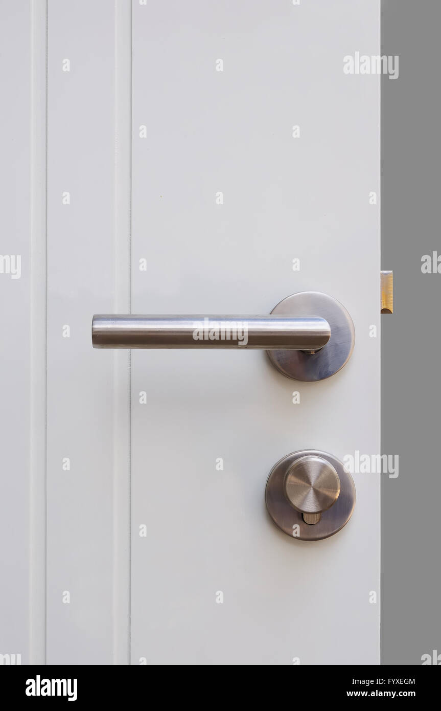 Aluminium door knob on the white door Stock Photo Alamy