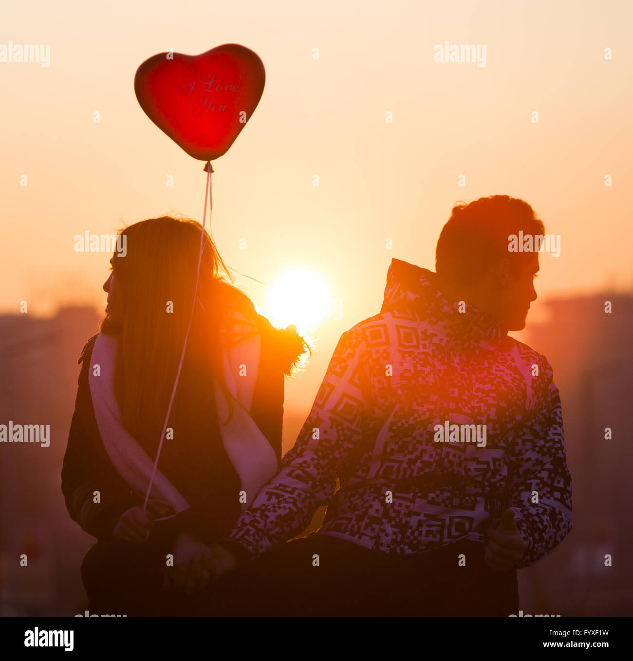 Young couple in love balloon heart Stock Photo - Alamy