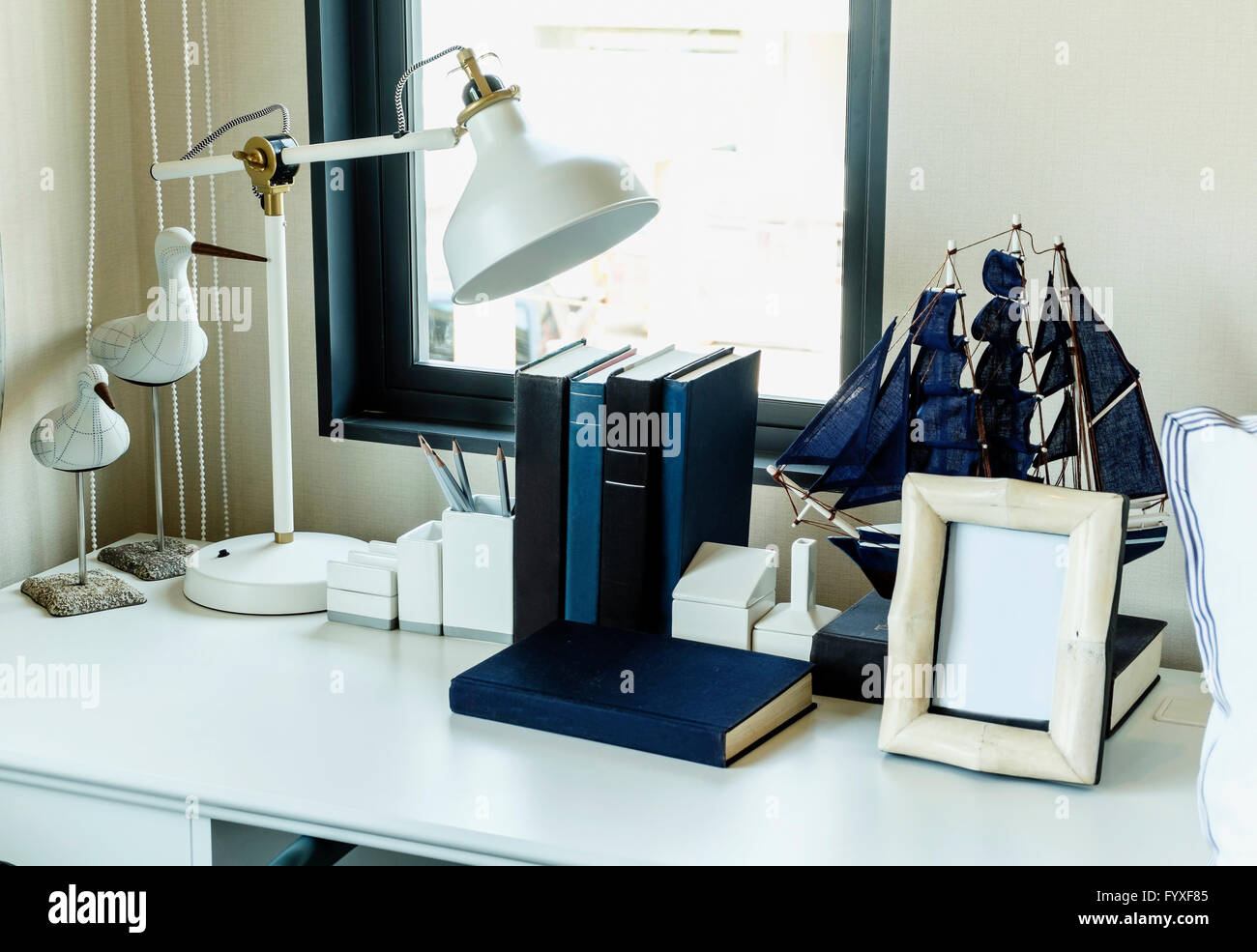 work table with lamp,pencil, books in a home Stock Photo