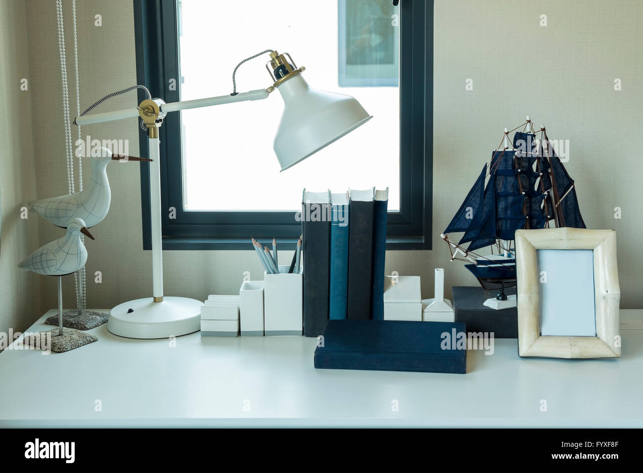 work table with lamp,pencil, book in a home Stock Photo - Alamy