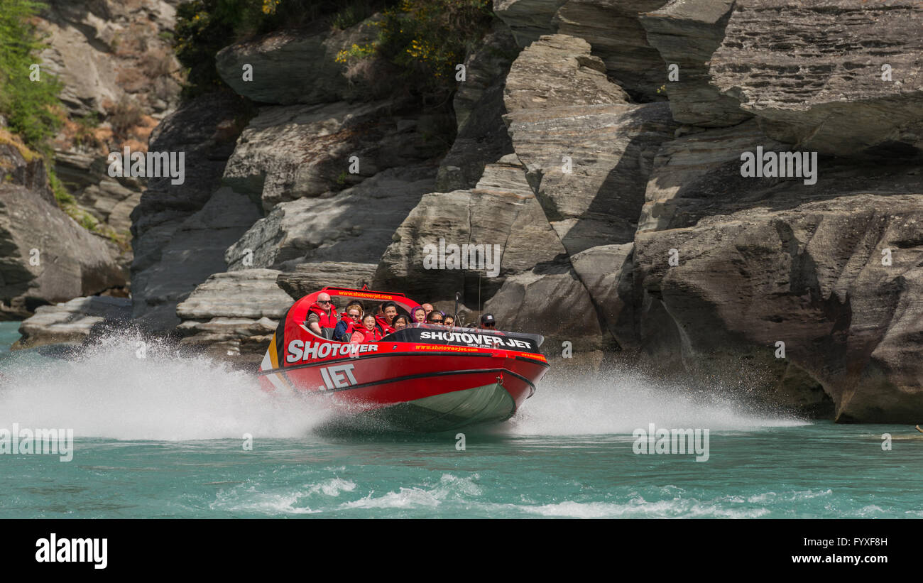 Group of tourists Jet boating on Shotover River at Arthurs Point, Queenstown, Otago, New Zealand's South Island. Stock Photo