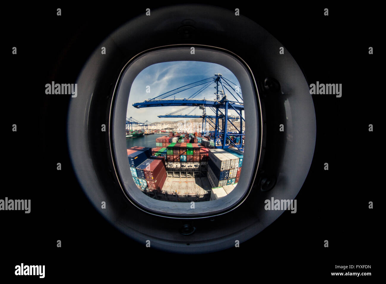 Watching a container ship being loaded from a window on one of the living quarters decks. Stock Photo
