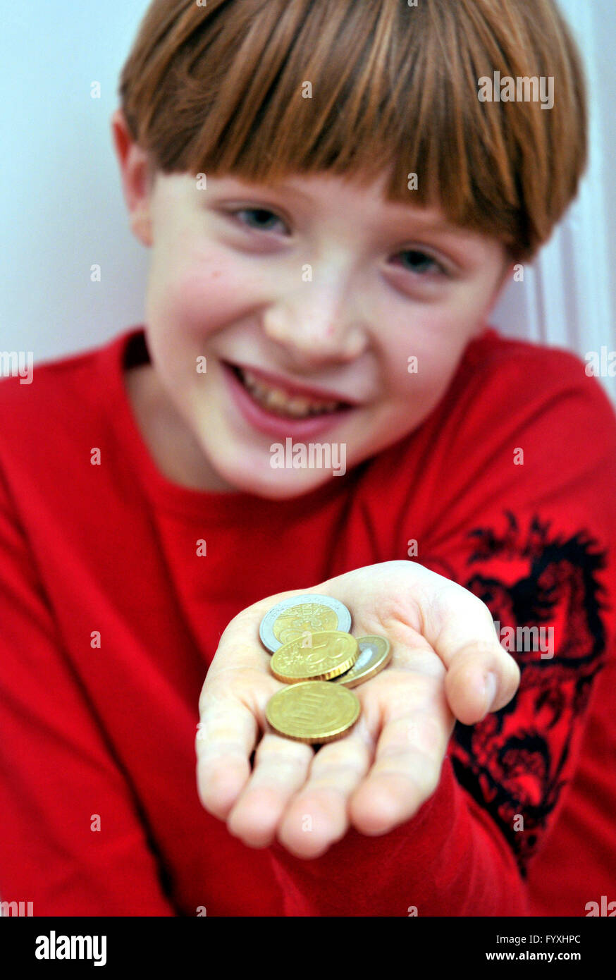 Boy with pocket money in hand, 9 years Stock Photo Alamy