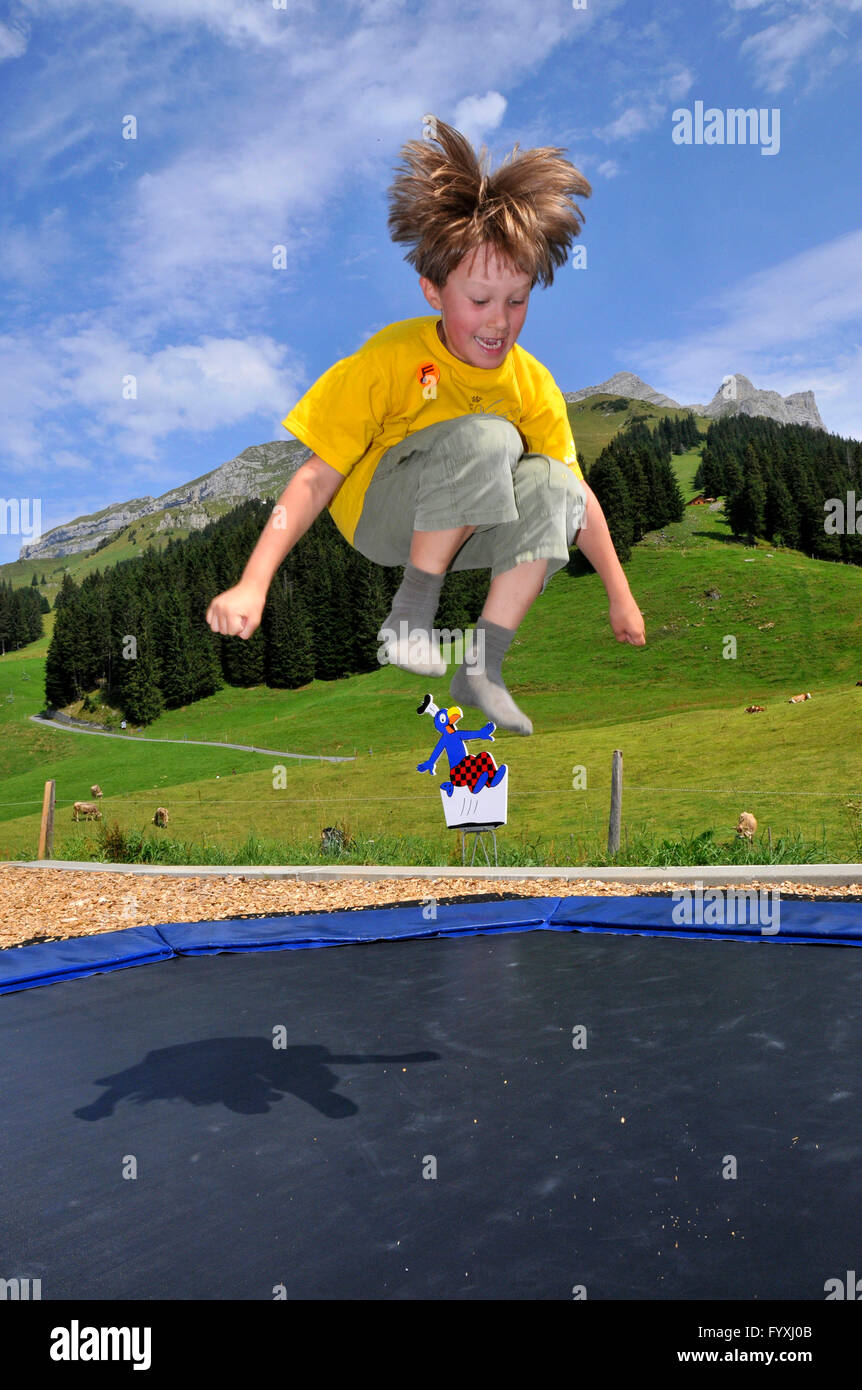 Boy On The Playground. Child Jumps On A Trampoline Stock Photo - Alamy
