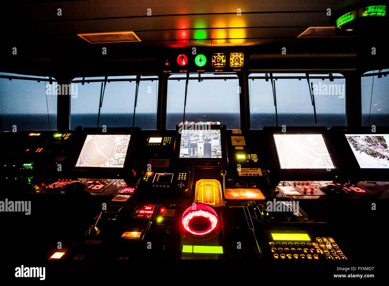 Navigation deck on board a container ship at sea during the early hours of the night. Stock Photo