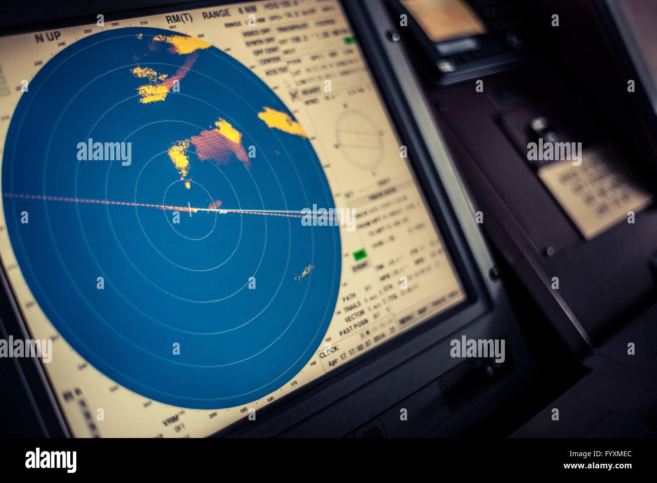 Radar display on an electronic map on the navigation deck of a container ship at sea. Stock Photo