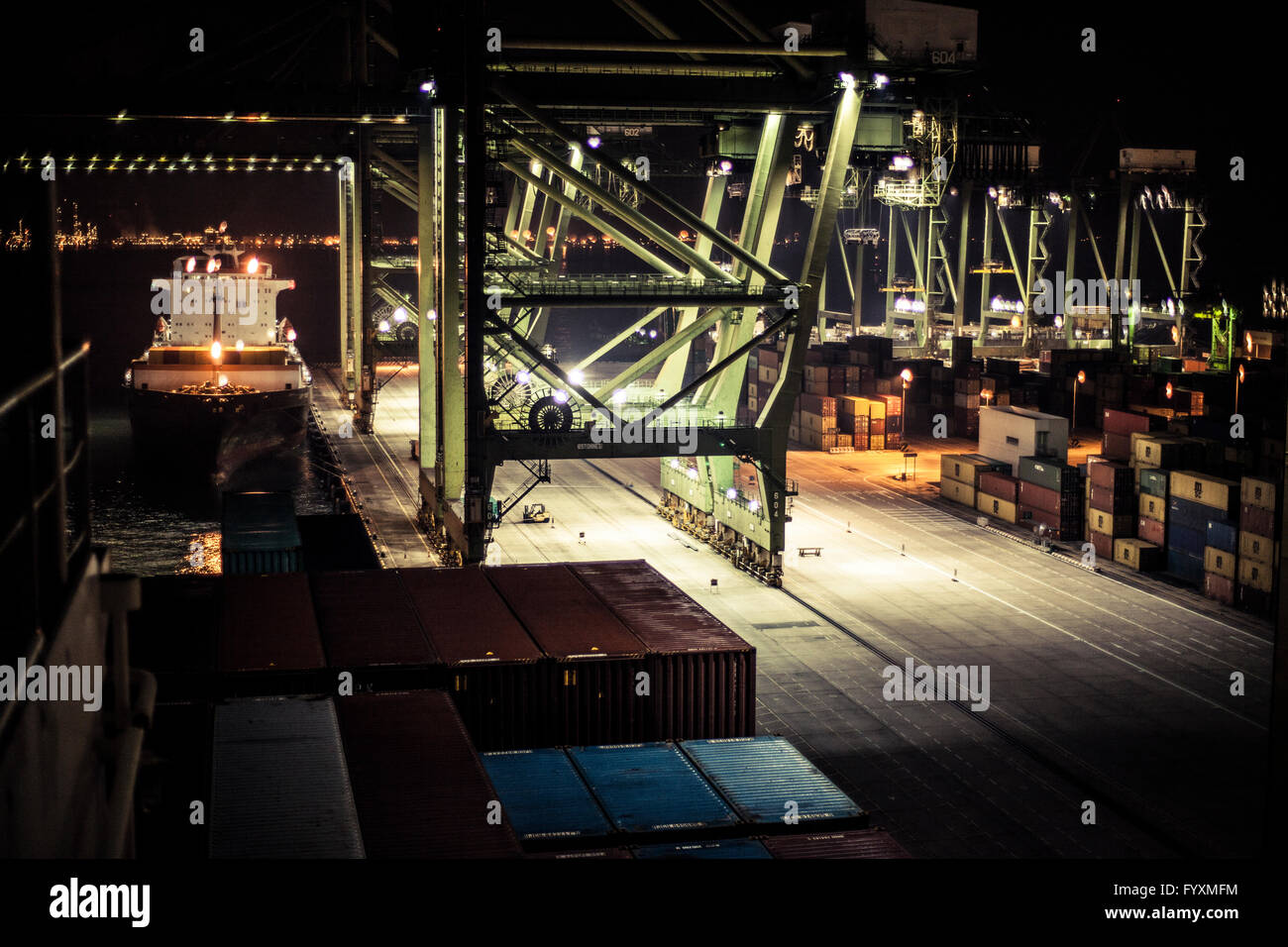 Container terminal in Singapore at night. Stock Photo