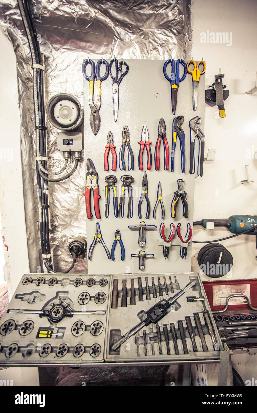Mechanic tools hanging on a wall Stock Photo