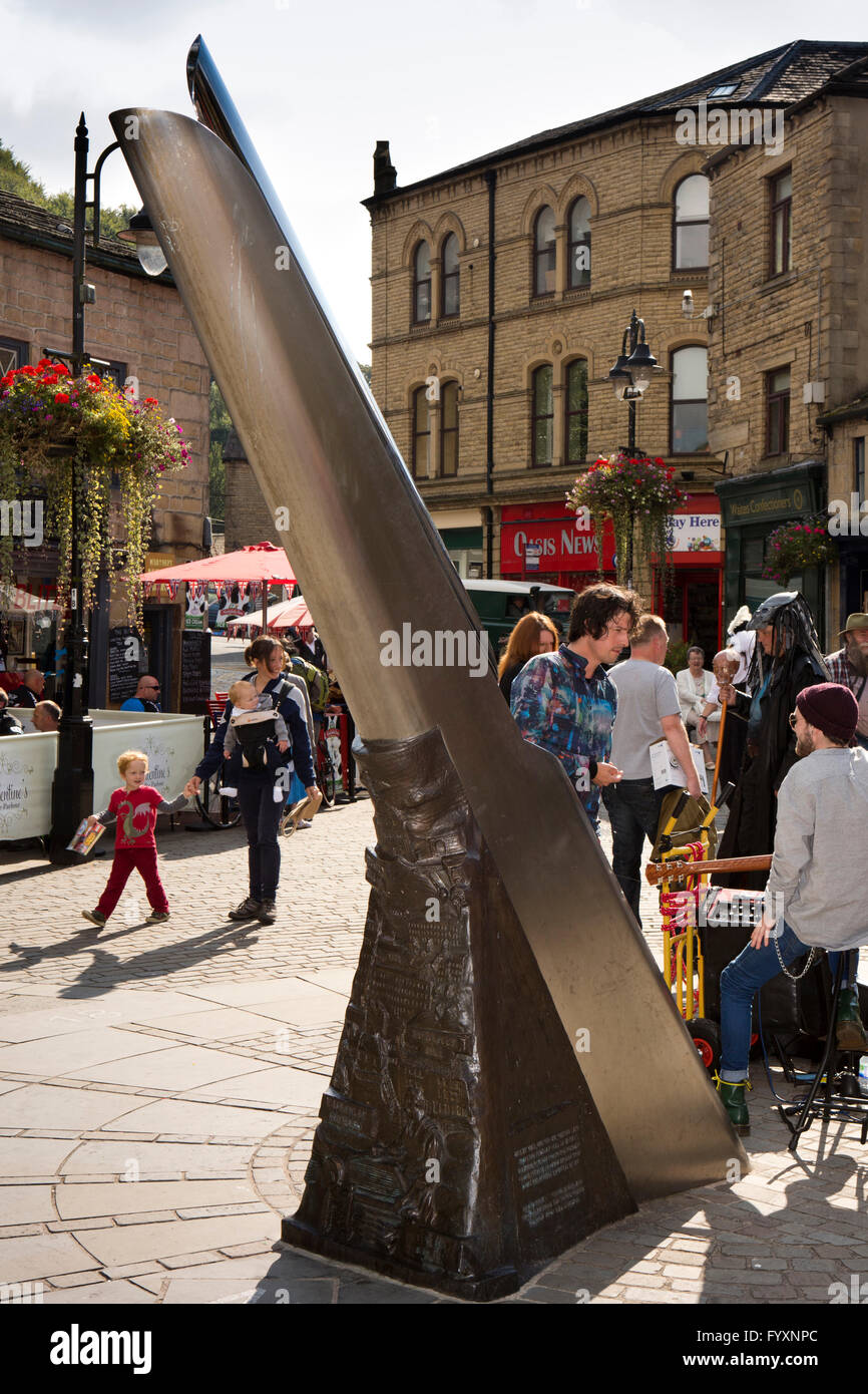 UK, England, Yorkshire, Calderdale, Hebden Bridge, St Georges Square, busker and visitors by Fustian Knife sculpture Stock Photo