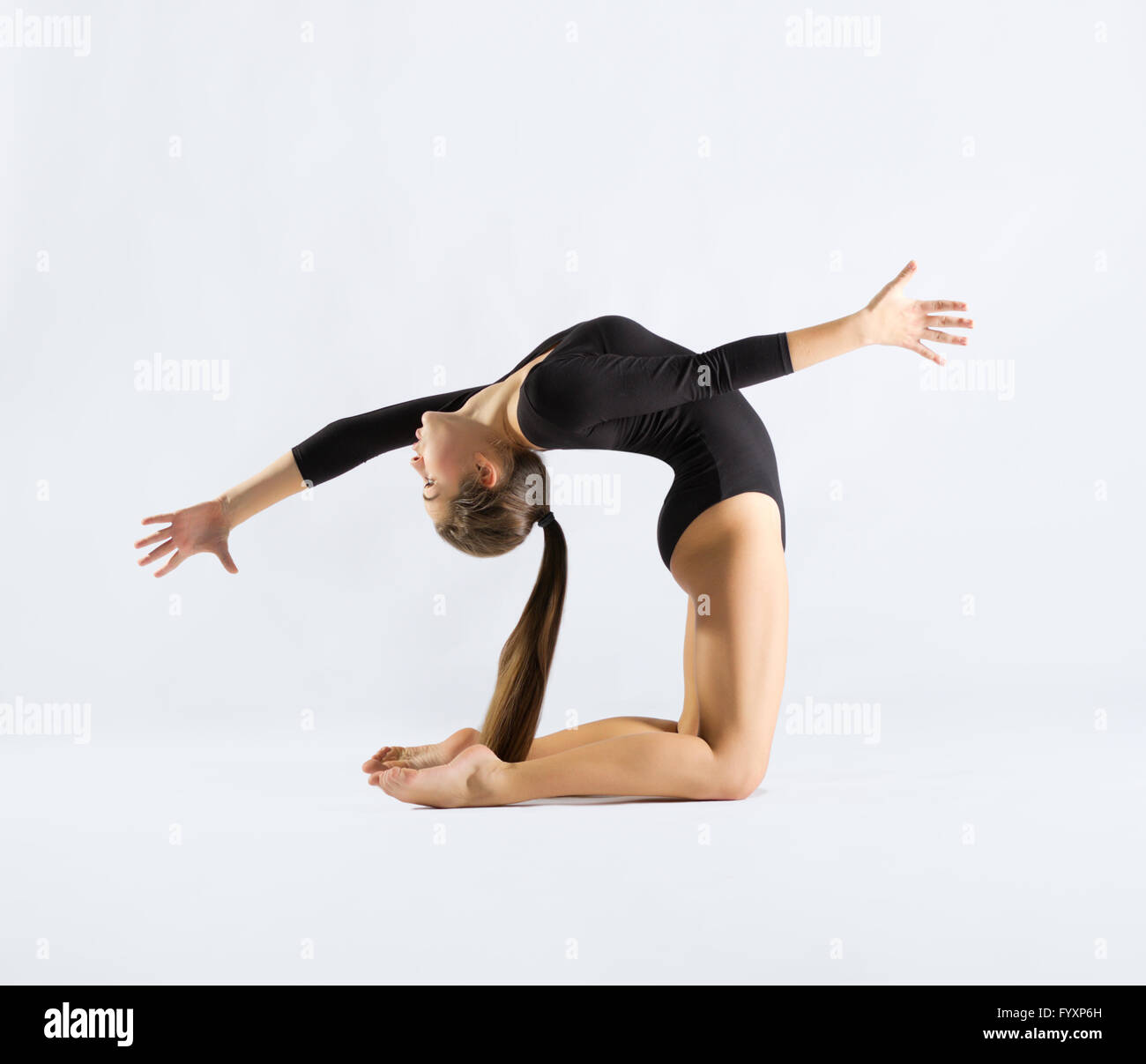 Young girl engaged art gymnastic on grey Stock Photo