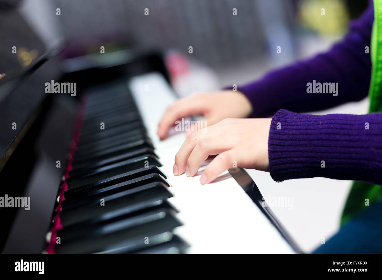 Asian cute boy playing piano at home Stock Photo