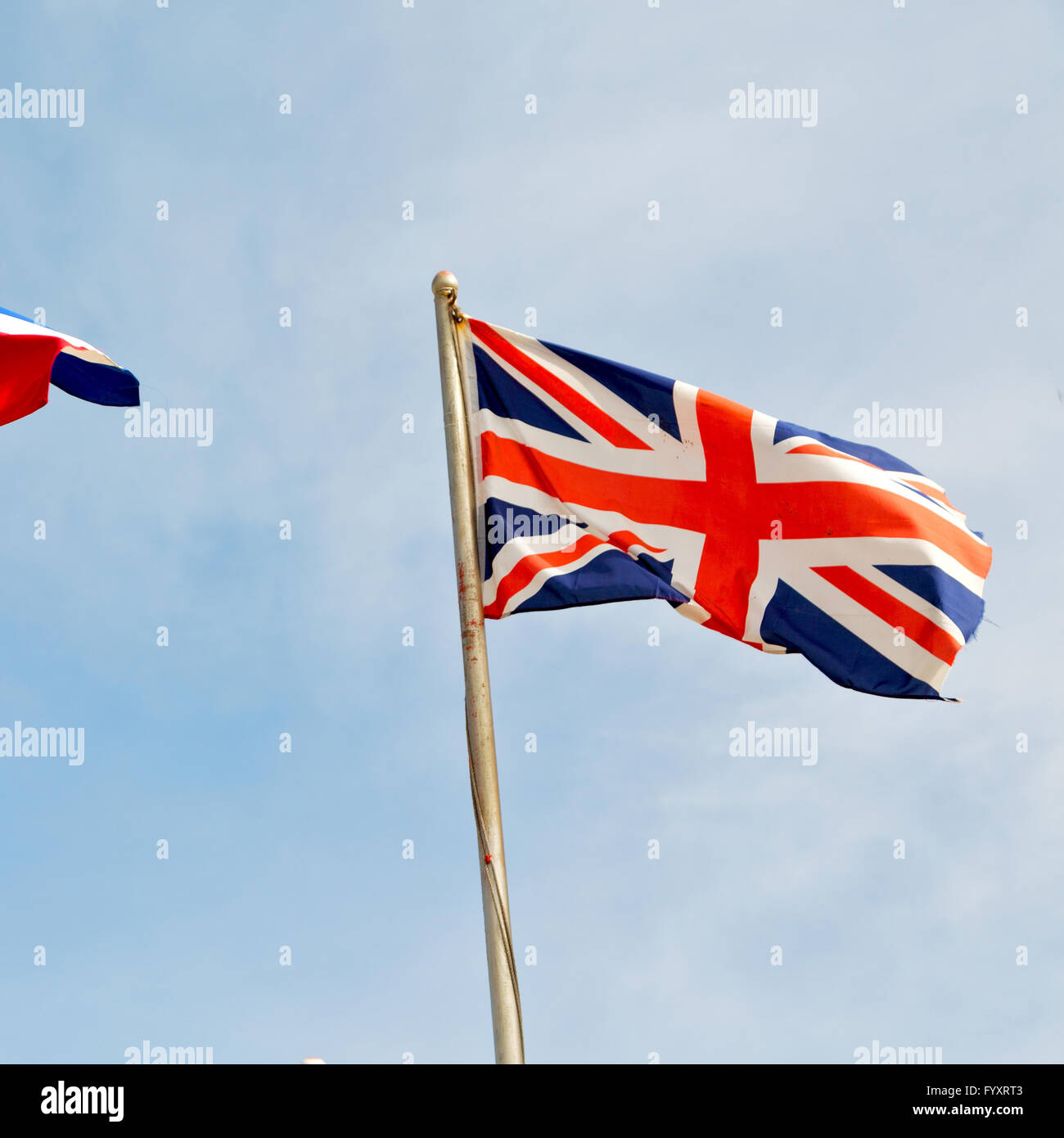 french waving flag in the blue sky british colour and wave Stock Photo