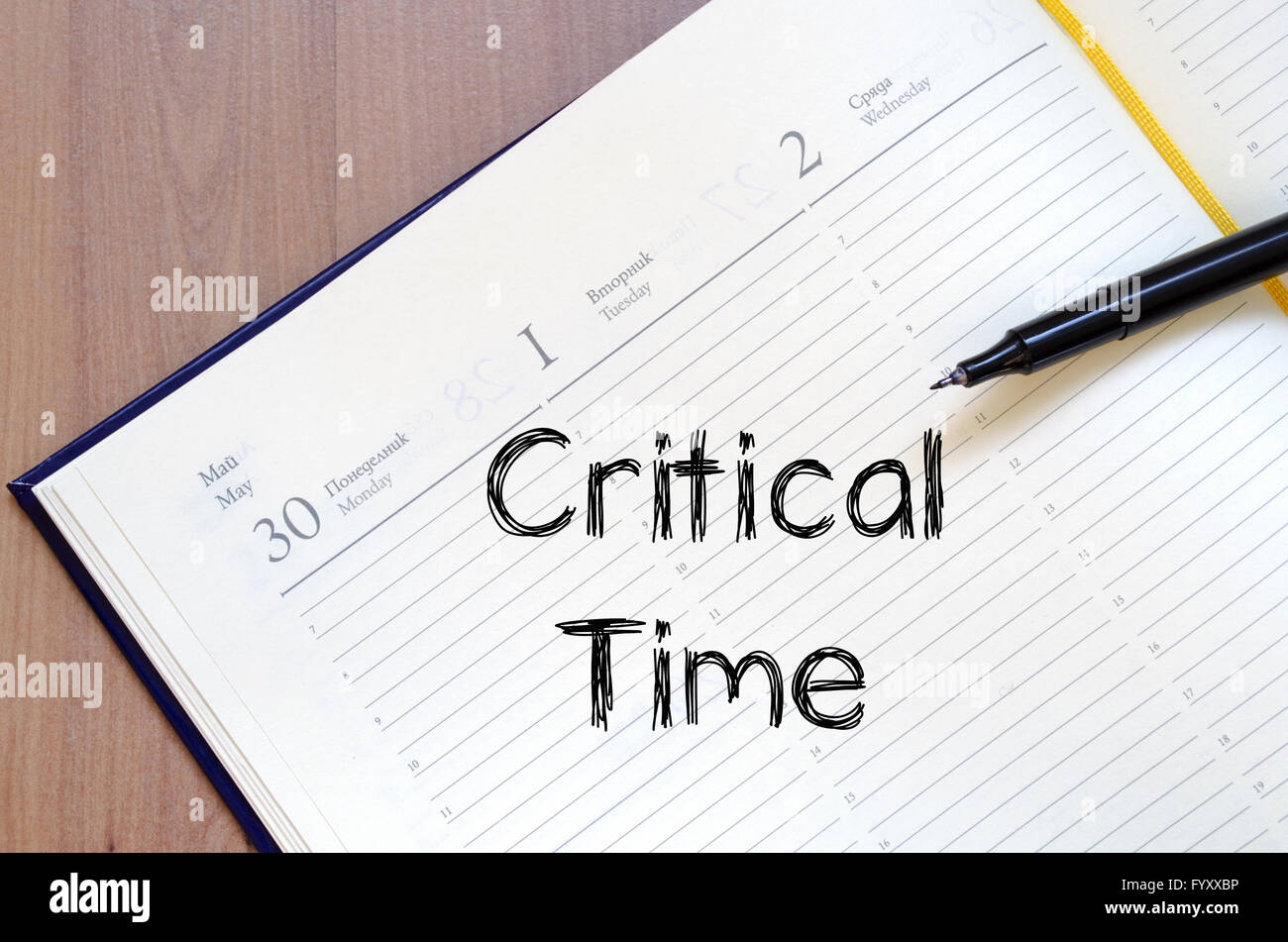 Critical time write on notebook Stock Photo - Alamy