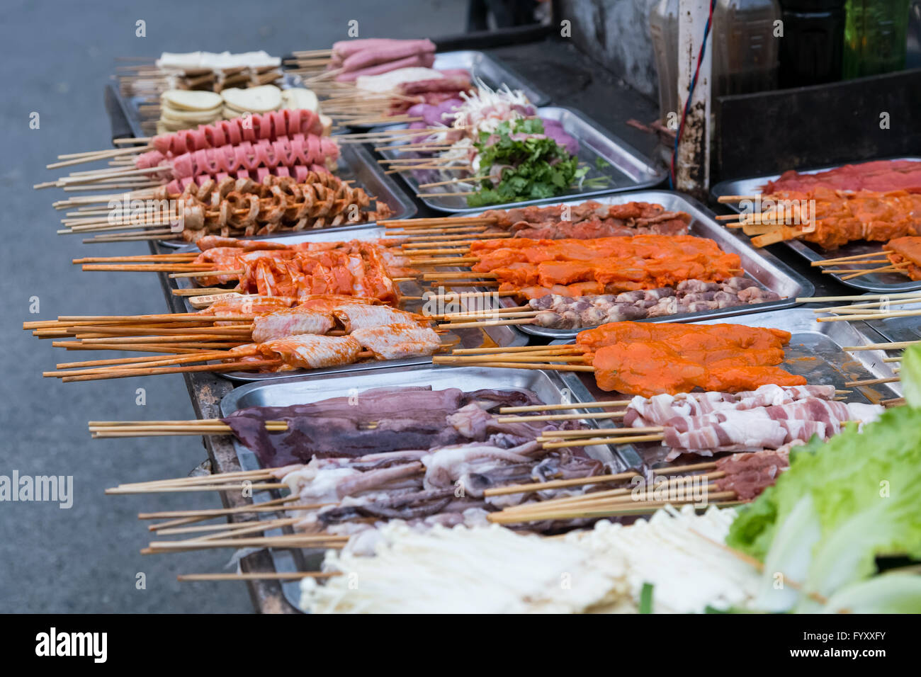 Oriental Asian barbeque sold at night street market in China Stock Photo
