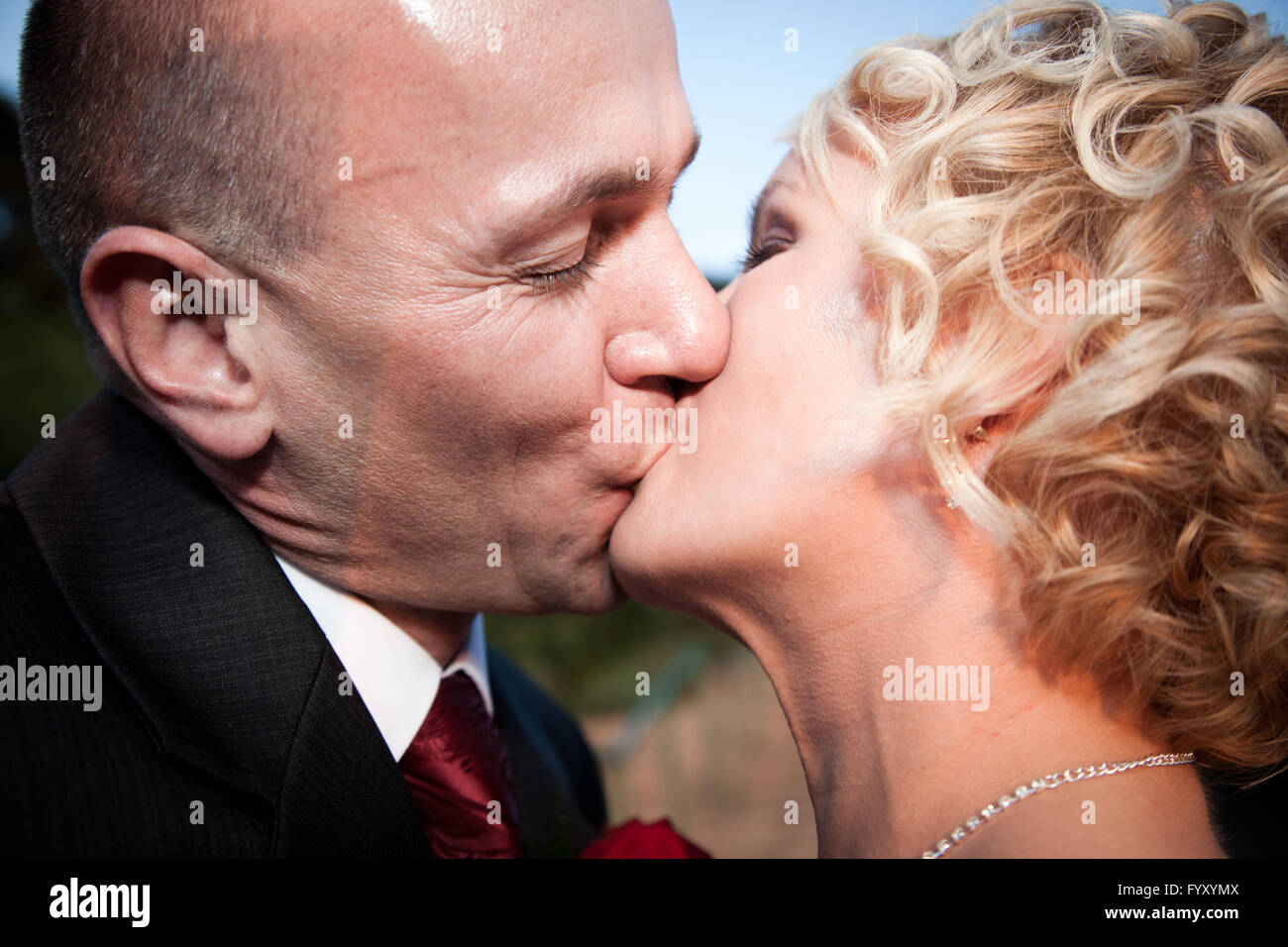 Happy bride and groom kissing Stock Photo