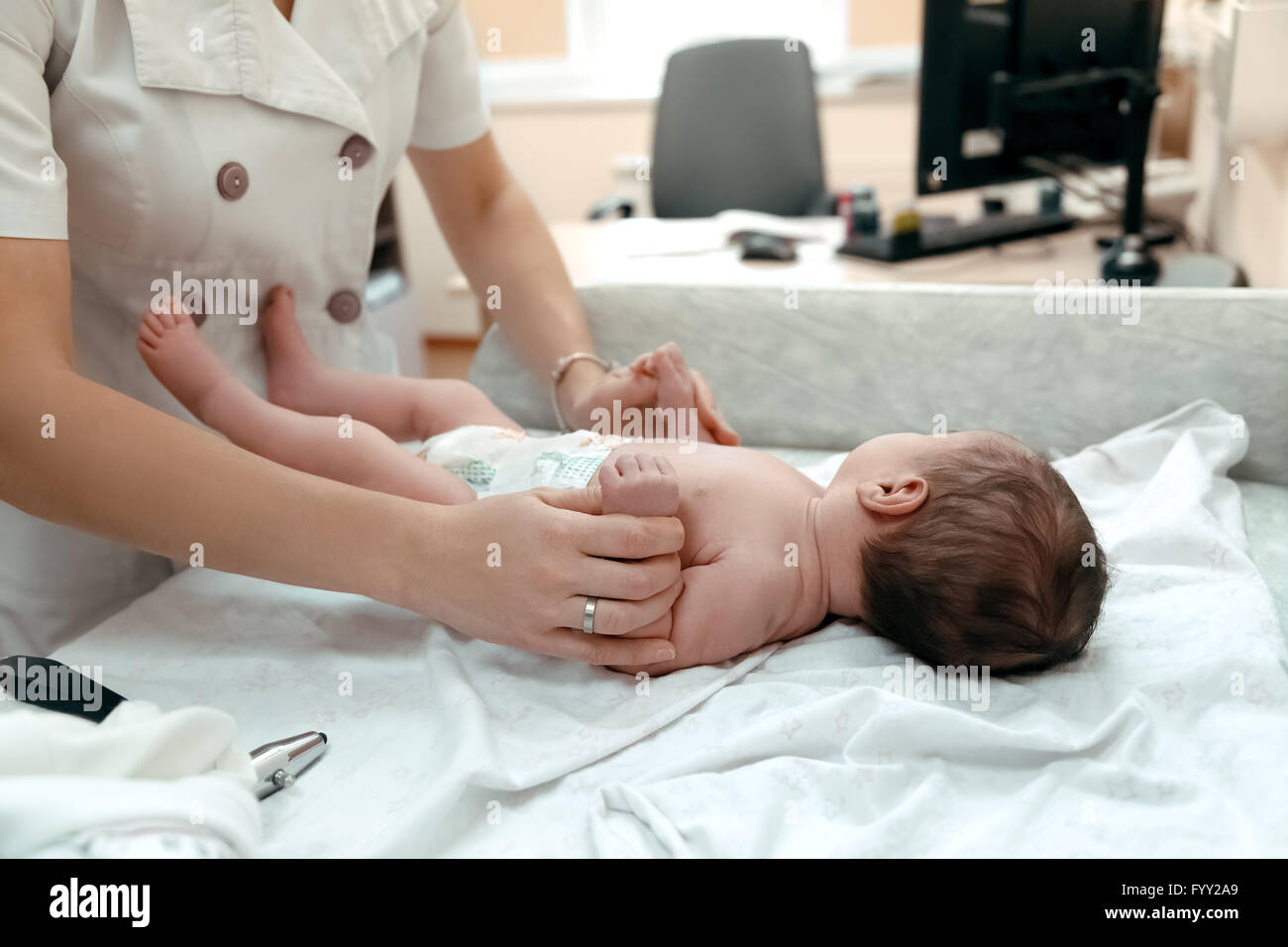 Pediatrician examining littlle newborn baby Stock Photo