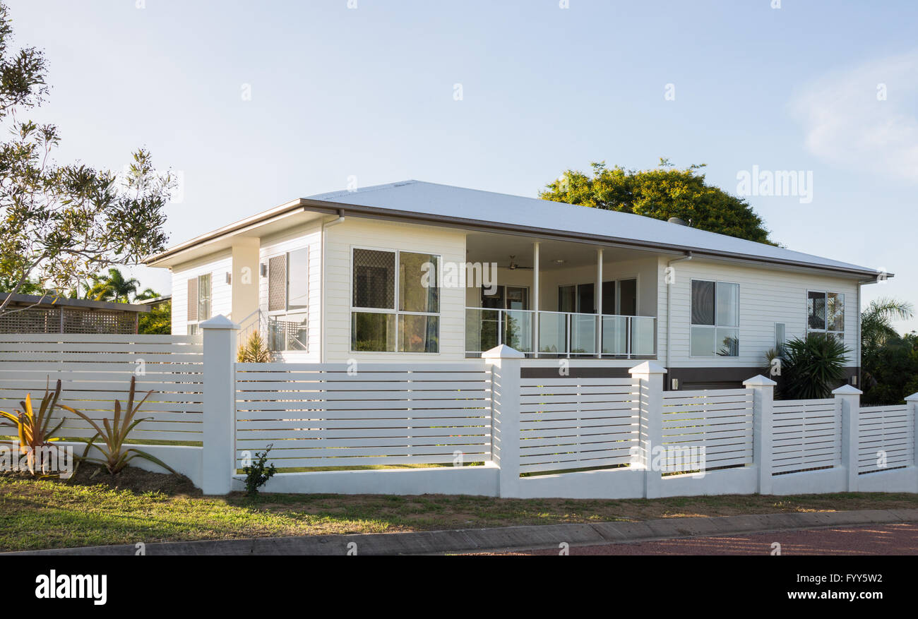 Contemporary house with concrete and timber paling fence, white modern home exterior Stock Photo
